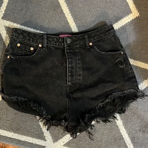 High wasted black washed shorts with distress fringe